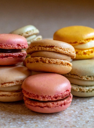 Still life of french macarons with different colored crispy meringue shells, and creamy filling