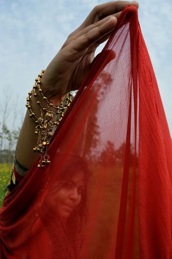 Portrait of teenage girl seen through scarf while standing outdoors