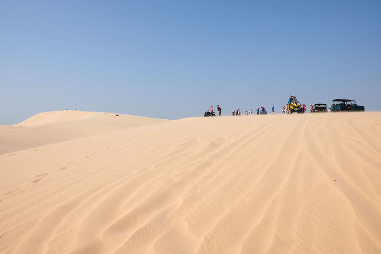 Scenic view of desert against clear blue sky