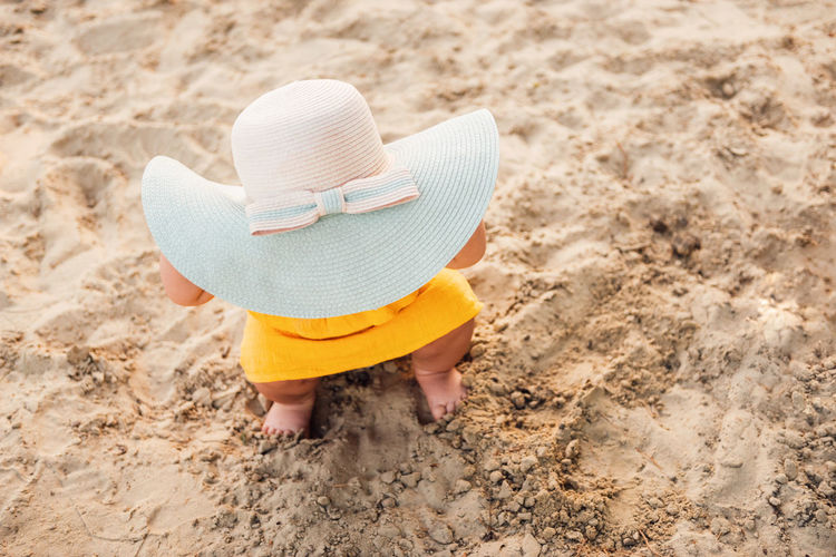 Rear view of child on sand