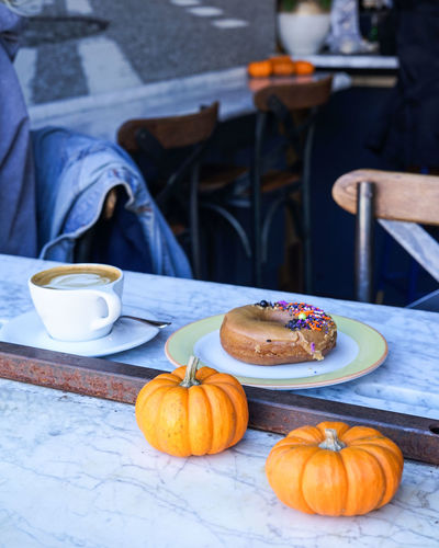 Morning cafe essentials with a coffee and donut.