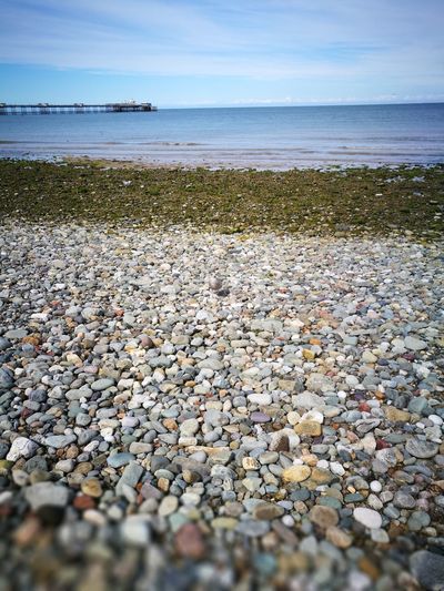 Pebbles on beach against sky