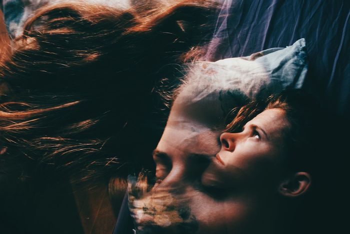 Multiple exposure of man and woman lying on bed