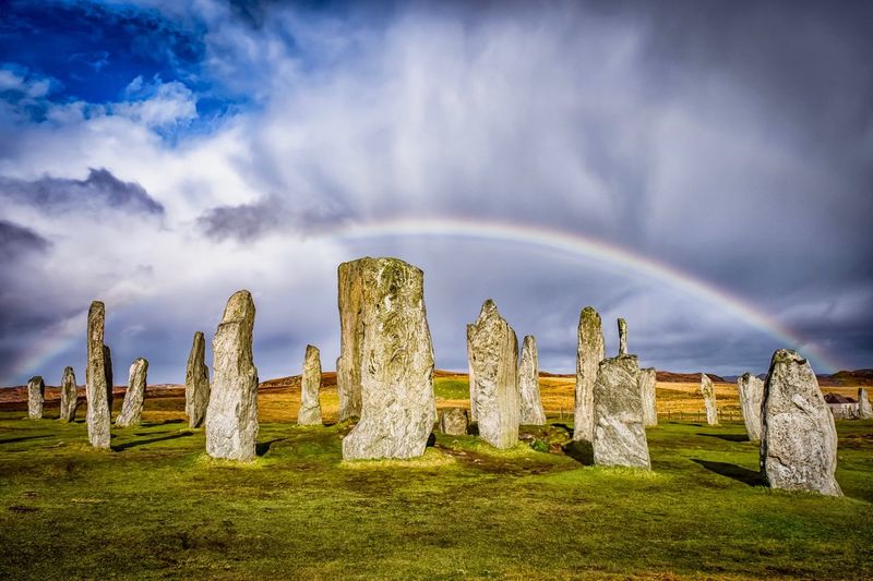Callanish standing stones against rainbow