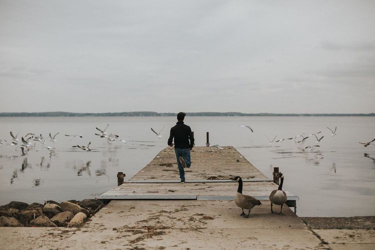 Man on beach against sky