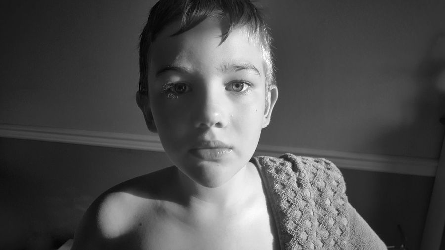 Portrait of shirtless boy at home