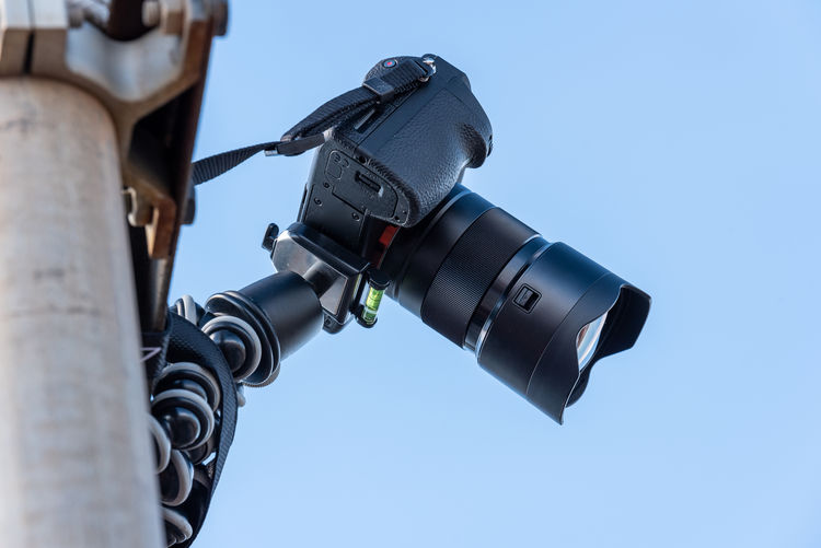 Low angle view of camera against clear sky