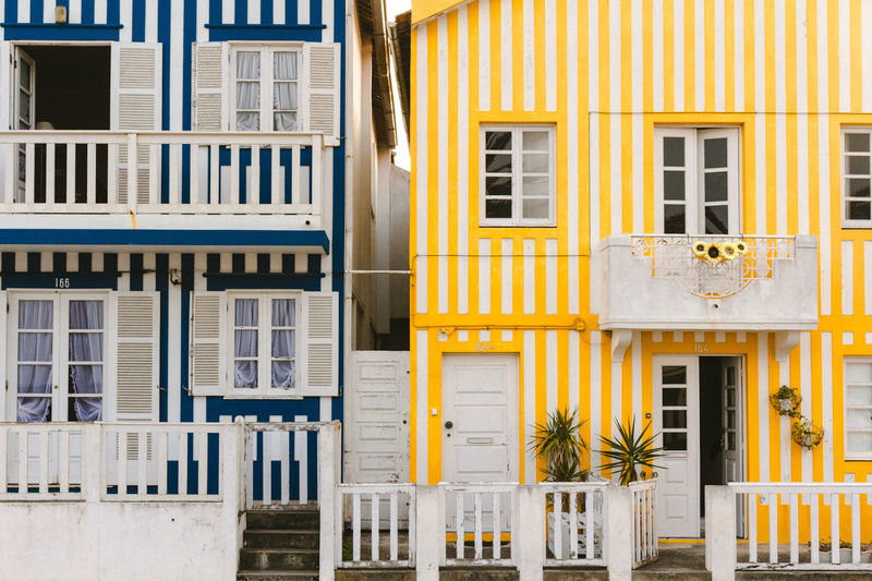 Facade of yellow  blue building stripes beach houses