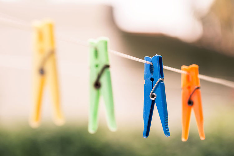 Close-up of clothespins hanging on clothesline