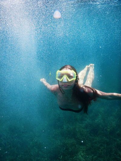 Young woman swimming in undersea