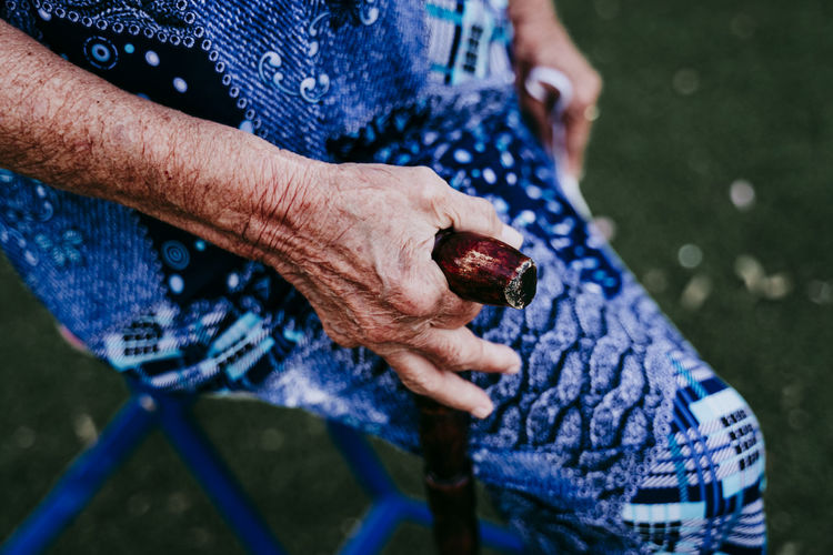Close-up of senior woman holding walking cane