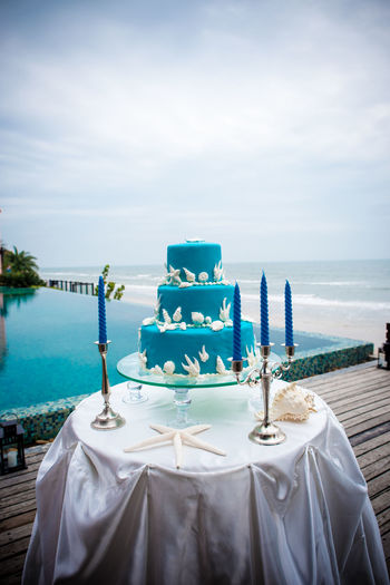 Blue wedding cake on wedding ceremony at seaside