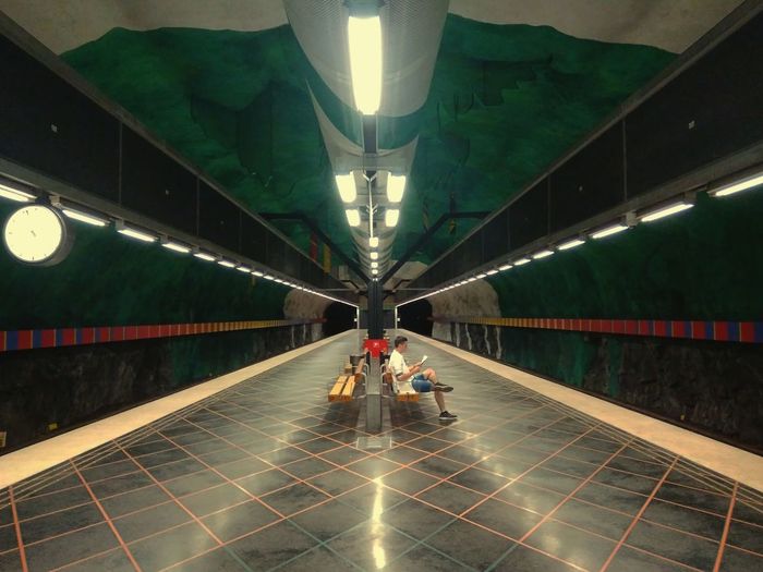People walking on illuminated subway station