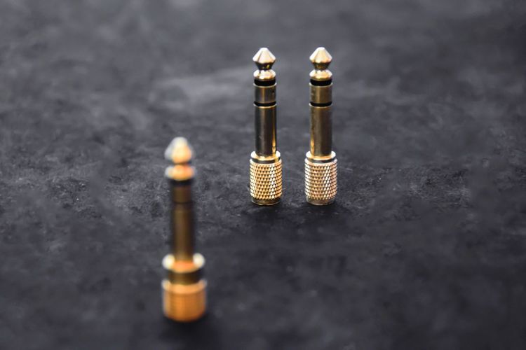 Close-up of golden phone connectors on table