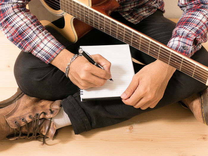 Man playing guitar on table