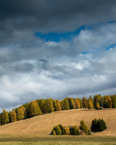 Landscape with beautiful autumn meadow field and the amazing dolomite rocky peaks.