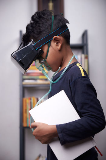 Side view of boy wearing virtual reality simulator