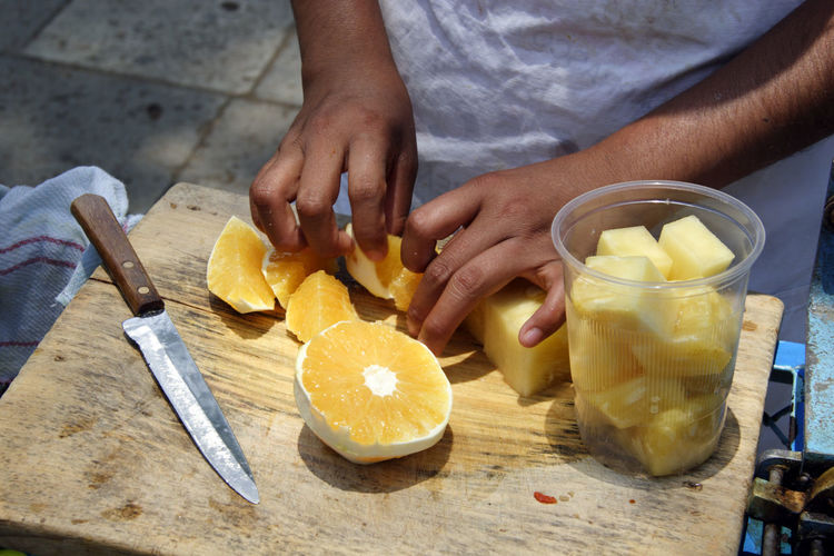Midsection of man preparing food on cutting board