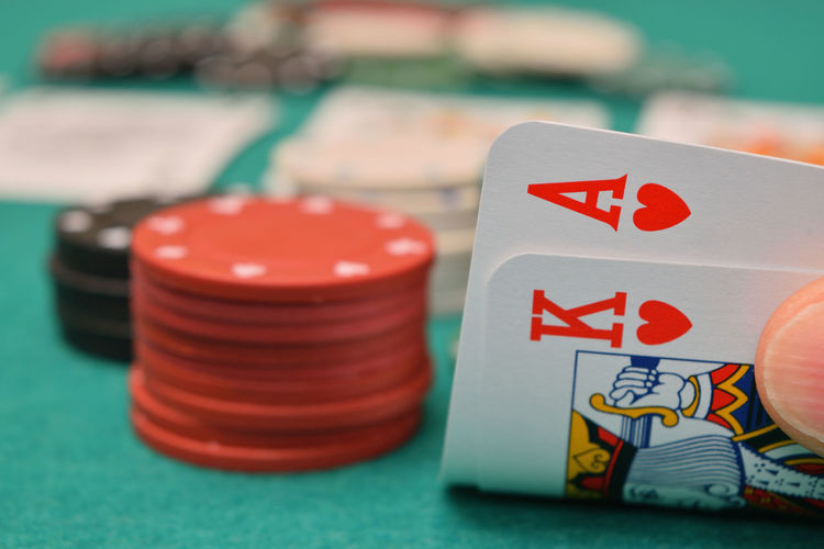 Close-up of gambling chip and cards on table
