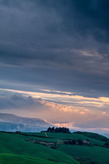 View of countryside landscape against cloudy sky