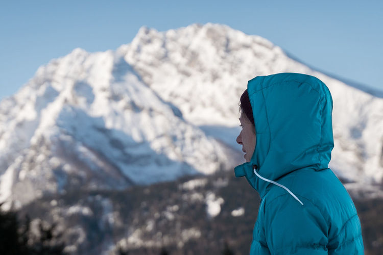 Side view of person on snowcapped mountain