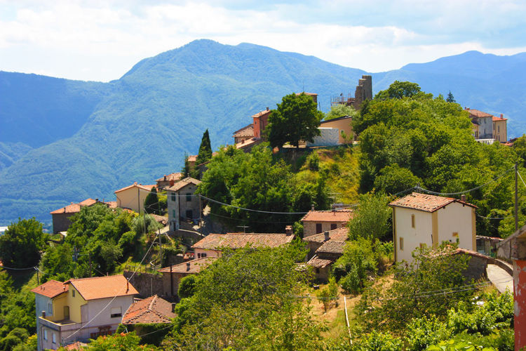 Italian top view of an ancient medieval tuscan village in green of the rural countryside in hills