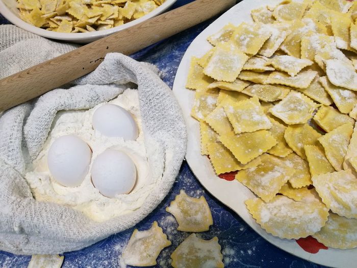 High angle view of ravioli pasta with eggs and flour in kitchen