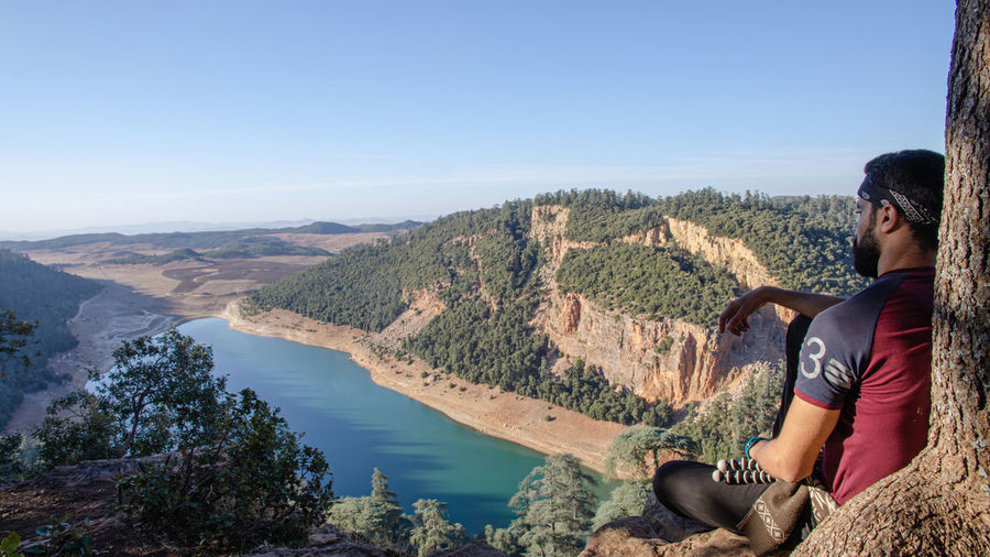 Hiking man looking at aguelmam azigza lake