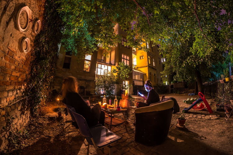 People relaxing on chair at night