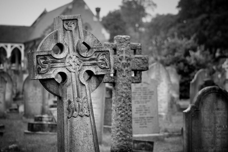 Close-up of tombstones at graveyard