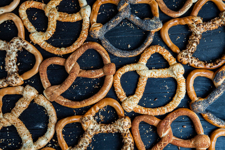 Fresh prepared homemade soft pretzels. different types of baked bagels 
