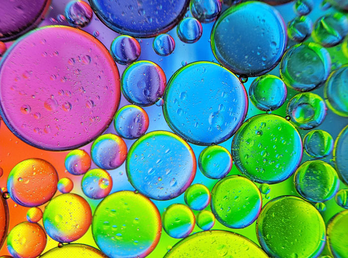 Colorful bubbles abstract background, oil bubbles in transparent liquid backdrop