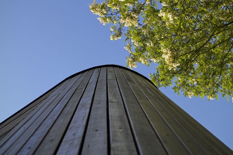 Low angle view of roof against clear blue sky