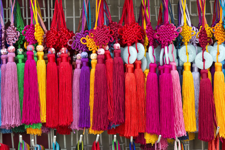 Close-up of multi colored decoration hanging for sale in market