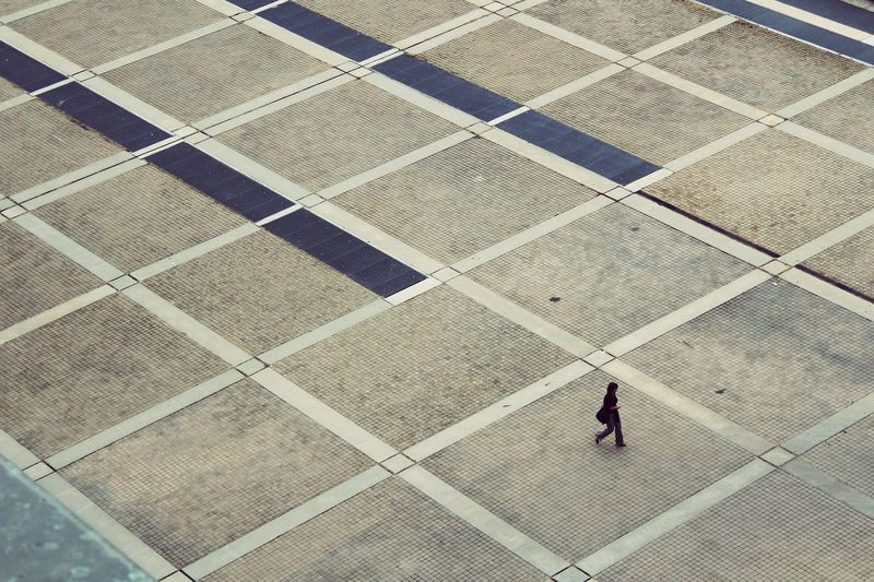 High angle view of woman walking on pavement