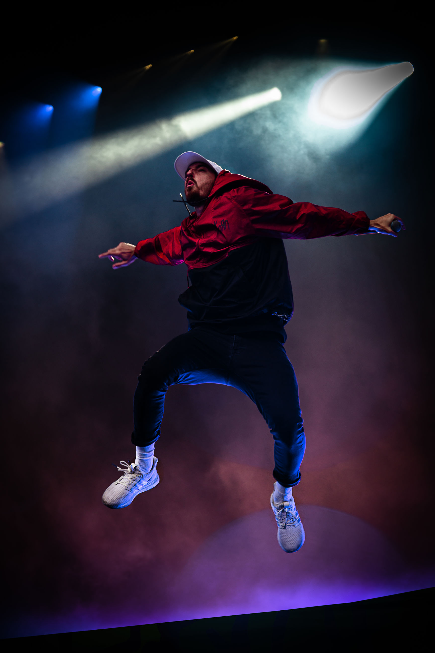 one person, full length, sport, night, jumping, illuminated, mid-air, performance, skill, motion, real people, indoors, stage - performance space, arts culture and entertainment, men, young adult, sports clothing, vitality, athlete, stage