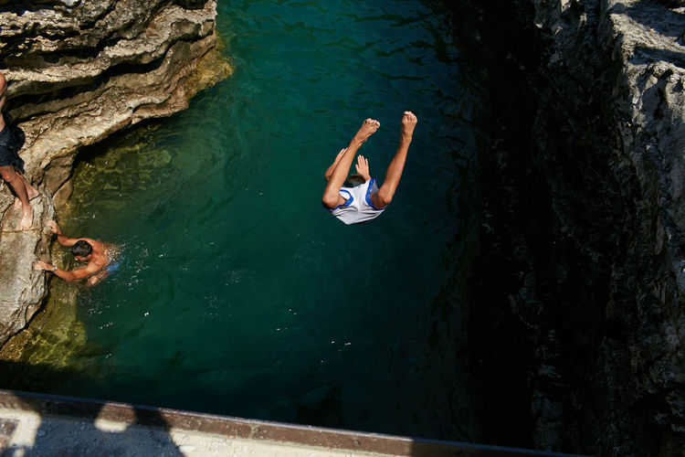 High angle view of man jumping in sea