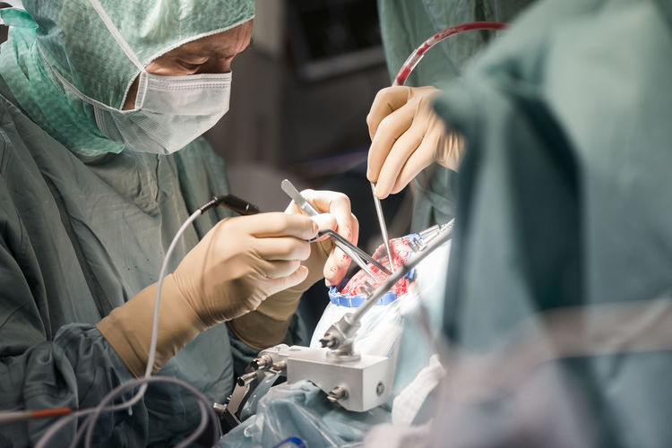 Neurosurgeons opening the cranium during an operation