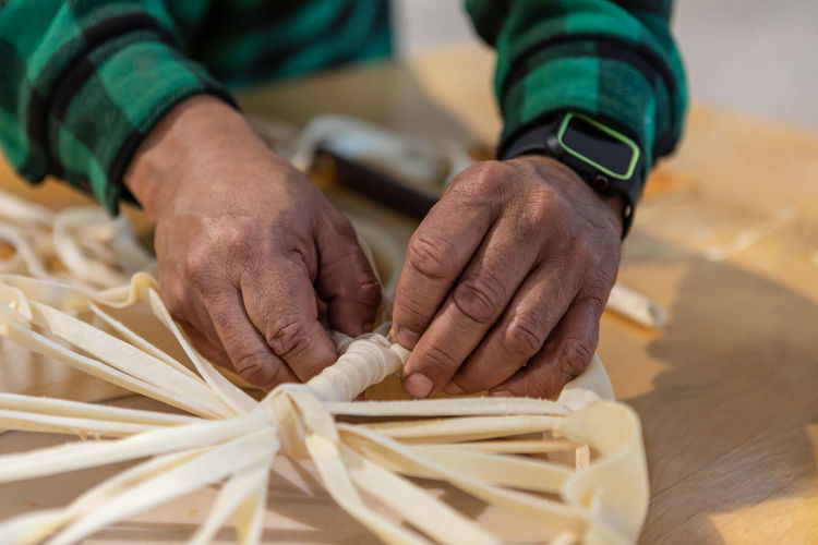 Midsection of man making musical instrument