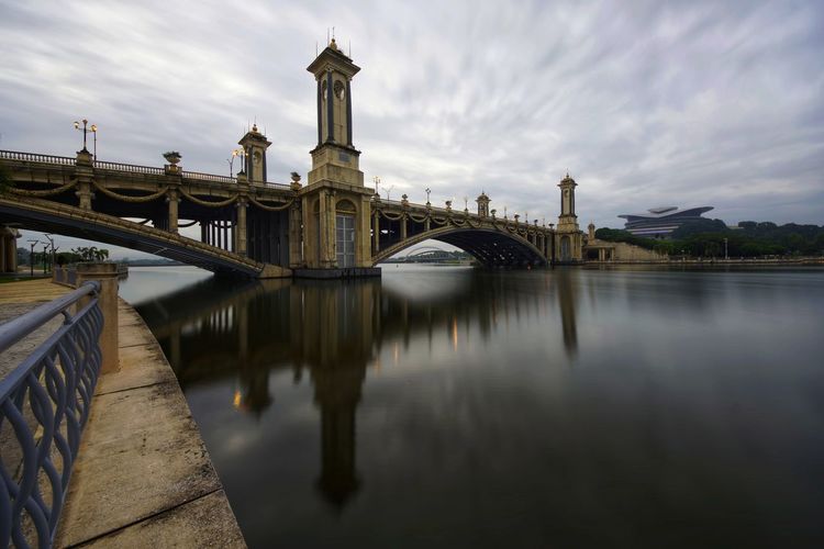 Bridge over river with buildings in background
