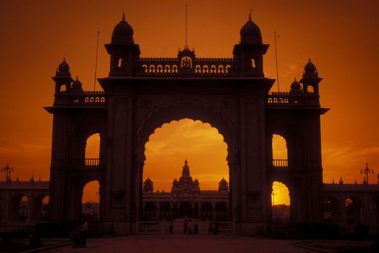 Entrance gate of mysore palace against sky during sunset