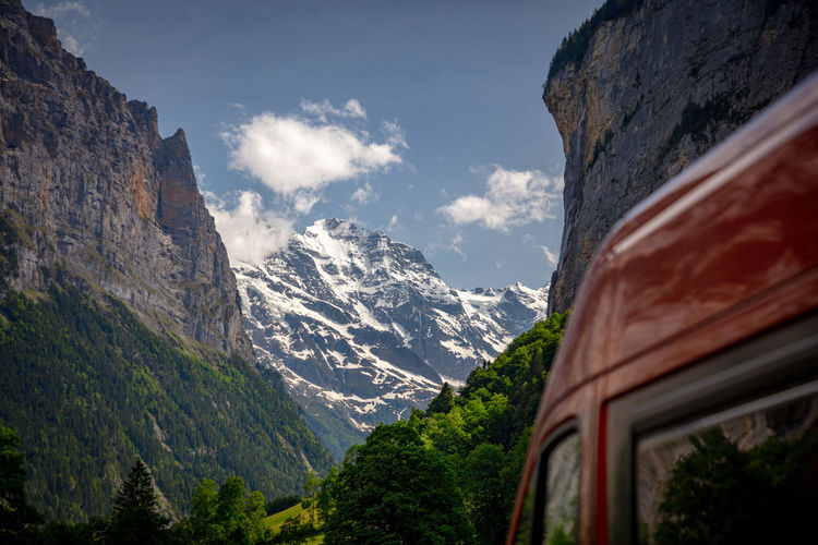 Scenic view of snowcapped mountains against sky with camper van, lauterbrunnen, switzerland.