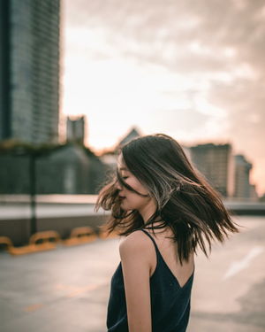 Portrait of young woman in city