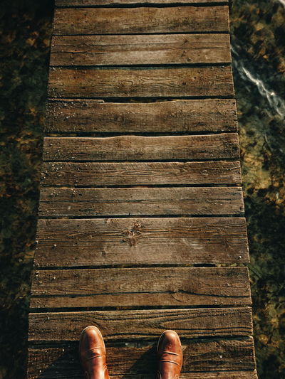 Low section of person on wooden plank