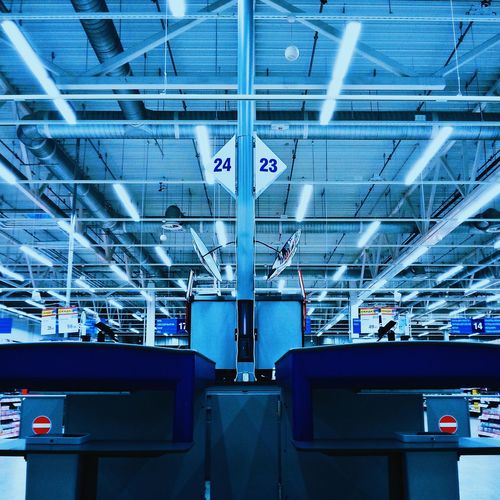Low angle view fluorescent lights hanging on ceiling of office