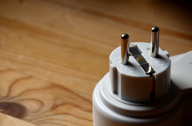 Close-up of electric plug on table
