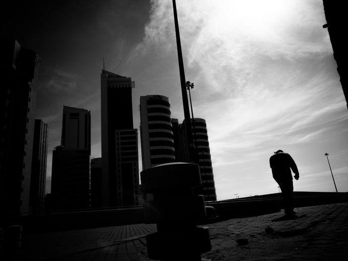 Silhouette of woman standing in city