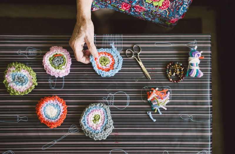Hands of senior woman holding crochet
