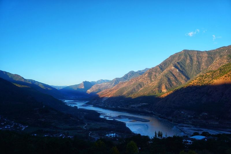 Scenic view of mountain range against blue sky