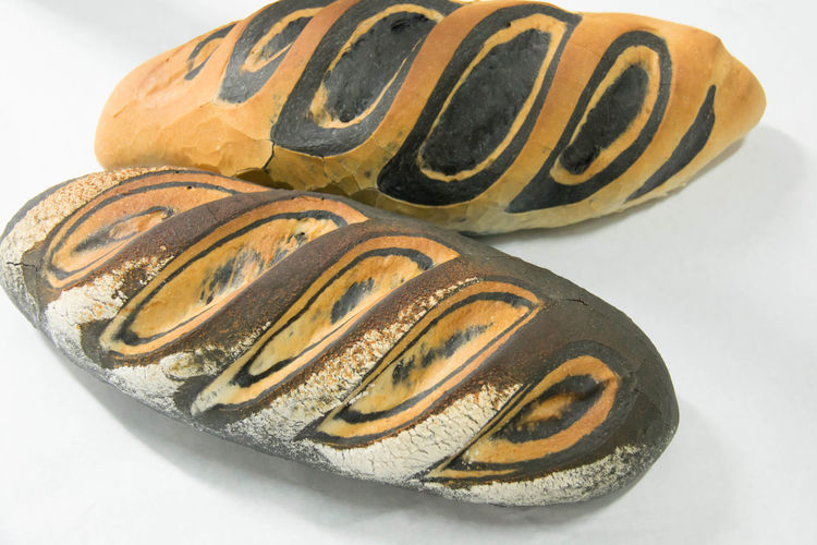 Directly above shot of bread loaves on gray background